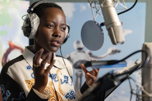 Actress Lupita Nyong'o seen speaking into a microphone as she performs the voice for her character in animated movie, "The Wild Robot."
