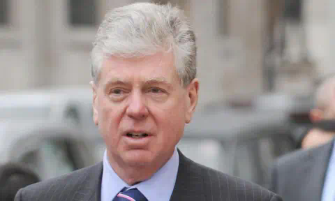 PA Media Michael Cole, Fayed's former spokesman wearing a pinstripe suit and a striped tie, pictured outside the High Court in 2008