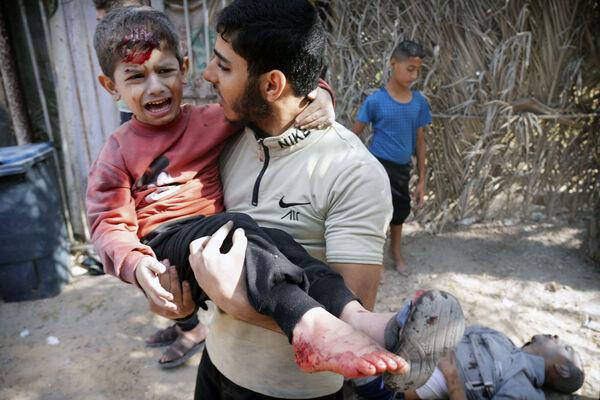 A wounded boy is carried after an Israeli strike in Deir Al-Balah, southern Gaza Strip, Thursday, Nov. 9, 2023. ( AP Photo/Hatem Moussa)