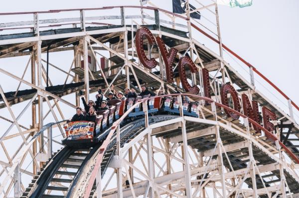 People ride the Cyclone on opening day 2024