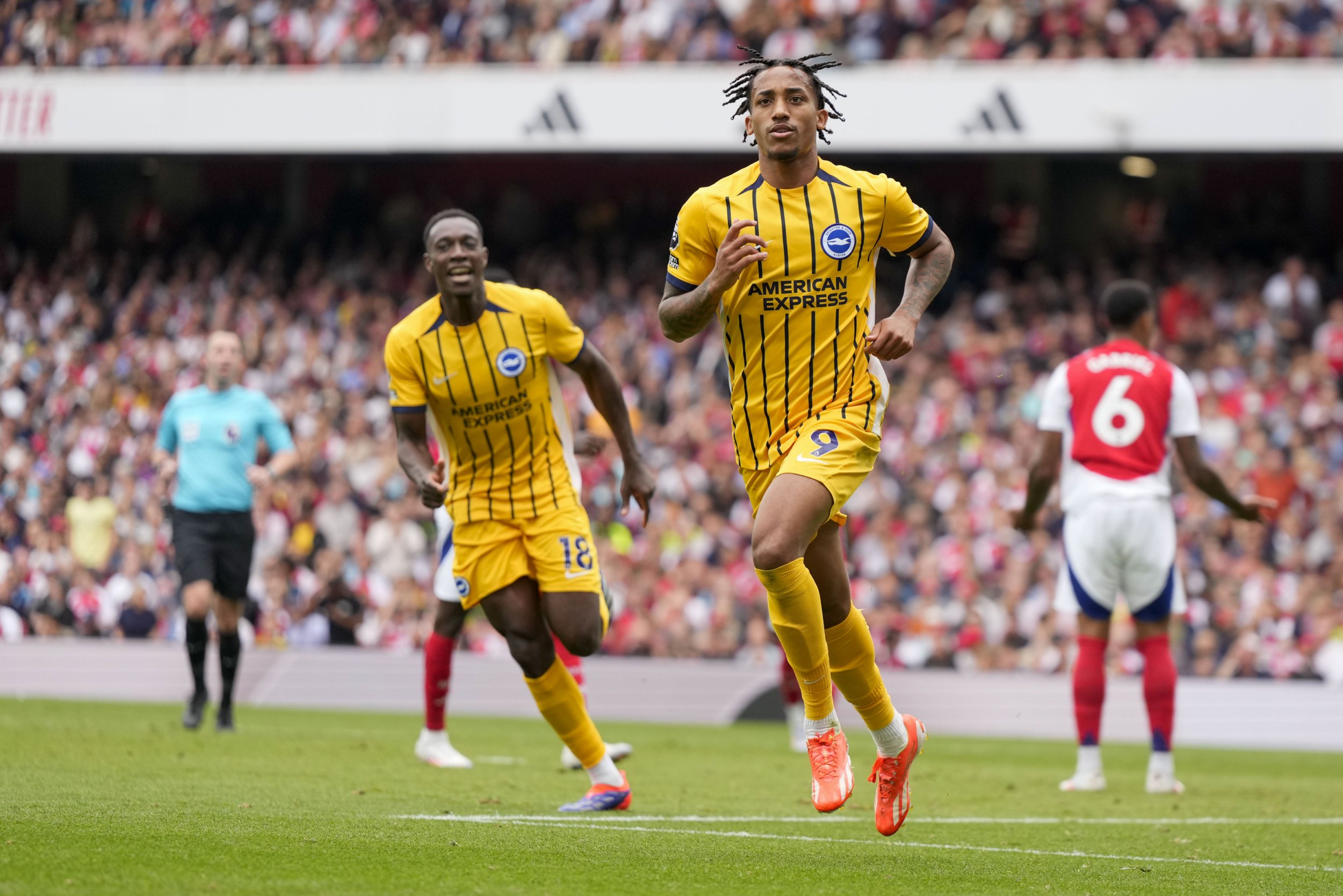 Brighton's Joao Pedro celebrates after scoring his side's opening goal during the English Premier League soccer match between Arsenal and Brighton, at Emirates Stadium