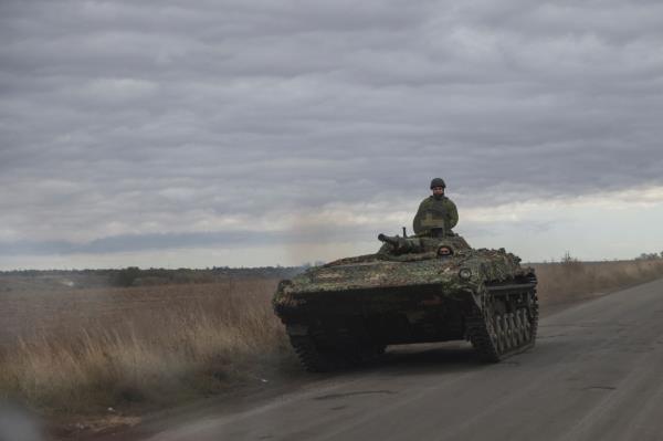 Ukrainian servicemen ride along a road in a BMP-1 armoured personnel carrier near a front line, amid Russia's attack on Ukraine, in Donetsk region, Ukraine October 13, 2023. 
