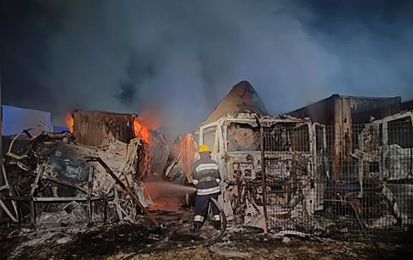 In this photo provided by the Odesa Region Administration, firefighters work to extinguish a fire in port infrastructure after a Russian rocket attack in Izmail, Odesa region, Ukraine, Tuesday, Sept. 26, 2023