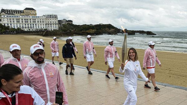 Man held in France over killings post as Olympic torch passes through Bordeaux
