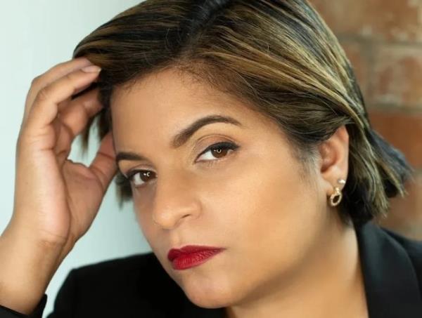 Sunita Thind with her hand on her head