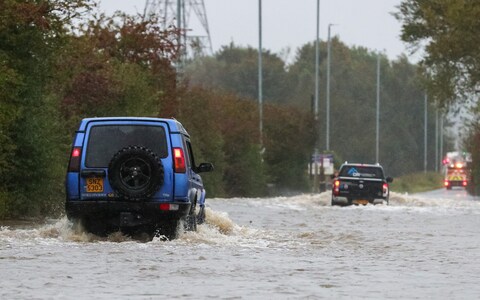 Two vehicles brave the flooded Barnsdale Road in Leeds after the River Aire bursts it's banks as Storm Babet batters the UK