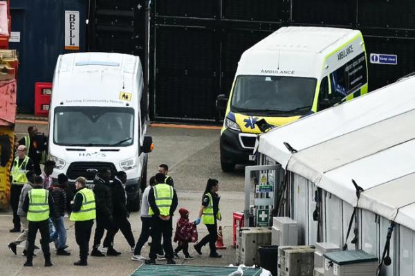 Migrants picked up at sea attempting to cross the English Channel from France are escorted ashore at the marina in Dover, southeast England. (File/AFP)
