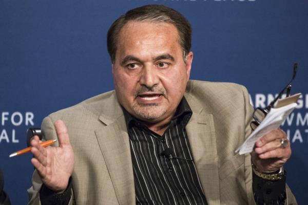 Mousavian at a press conference, wearing a tan jacket