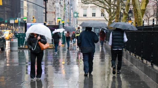 New Yorkers walk in the heavy rain near City Hall Park on Tuesday, April 2, 2024. (Luiz C. Ribeiro for NY Daily News)