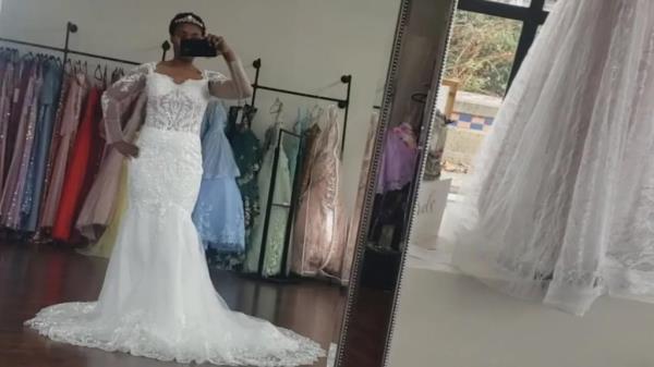 Akila Mwongozi is seen in the wedding dress she spent $1,000 and was never given after a bridal shop shut down on hardly any notice.