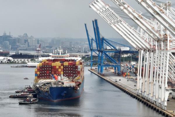 BALTIMORE, MARYLAND - MAY 20: In this aerial view, the damaged container ship Dali is maneuvered into the Seagirt Marine Terminal on May 20, 2024 in Baltimore, Maryland. On March 26th the Dali crashed into the Francis Scott Key Bridge, causing it to collapse killing six construction workers, and closing the Patapsco River and the Port of Baltimore for weeks. (Photo by Chip Somodevilla/Getty Images)