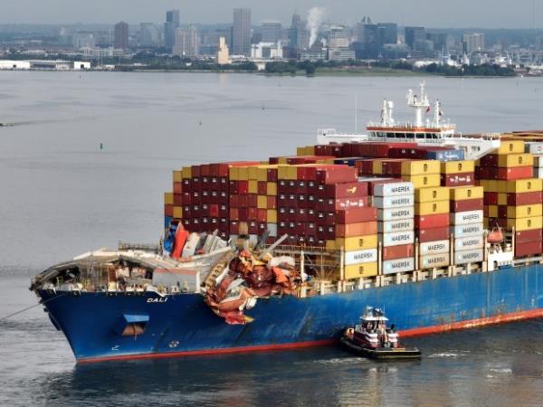 BALTIMORE, MARYLAND - MAY 20: In this aerial view, tug boats maneuver the damaged container ship Dali through the Port of Baltimore and into the Seagirt Marine Terminal on May 20, 2024 in Baltimore, Maryland. On March 26th the Dali crashed into the Francis Scott Key Bridge, causing it to collapse killing six construction workers, and closing the Patapsco River and the Port of Baltimore for weeks. (Photo by Chip Somodevilla/Getty Images)