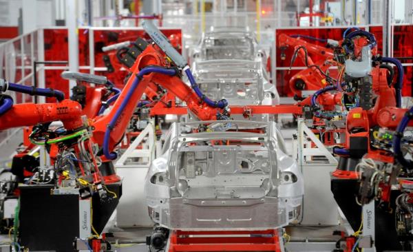 Robotic arms assemble Tesla's Model S sedans