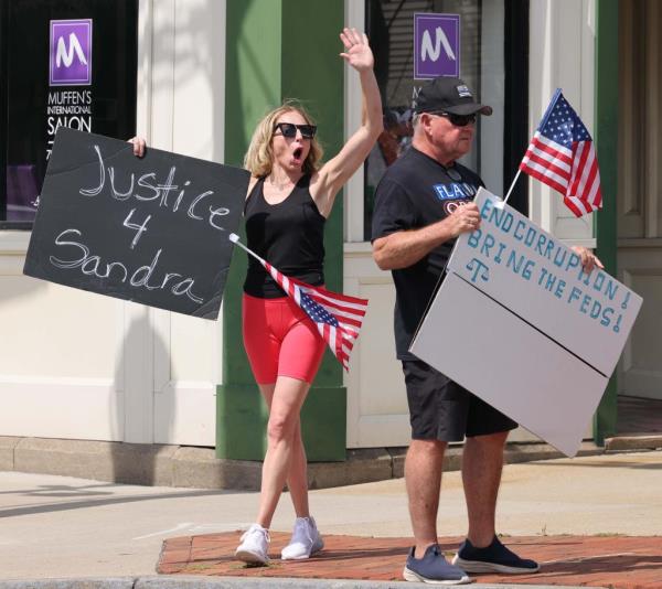 Demonstrators hold signs for justice for Sandra Birchmore at Town Hall in Stoughton on Saturday, July 20, 2024.