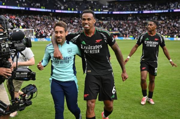 Nicolas Jover, First team coach at Arsenal and Gabriel Magalhaes celebrates victory together after the Premier League match between Tottenham Hotspur FC and Arsenal FC