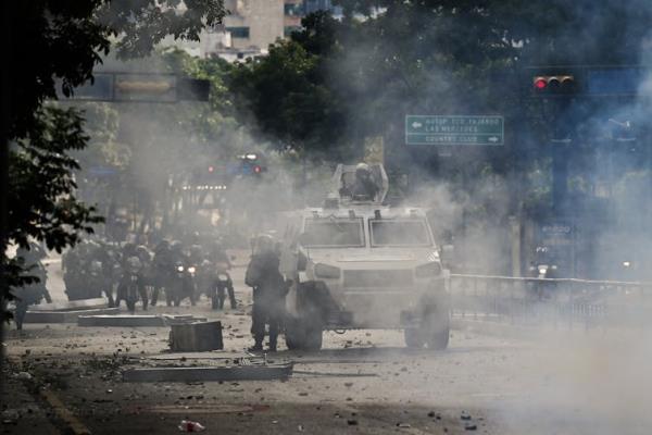 An armored vehicle is seen in a cloud.