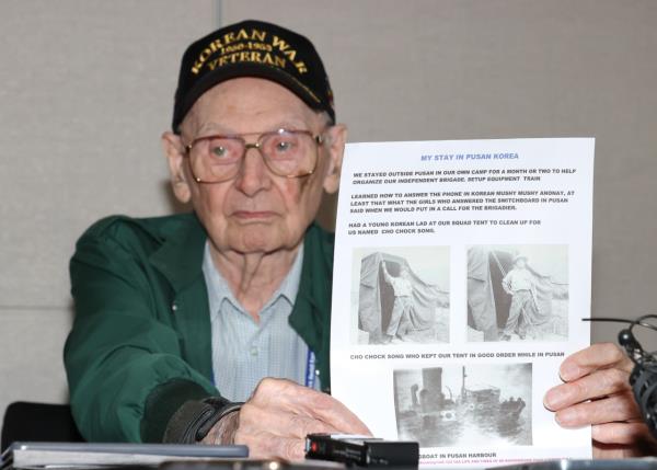 Canadian veteran Edward Buckner holds a photo of