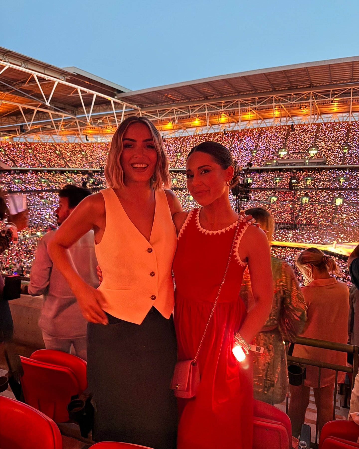 Louise Thompson and Frankie Bridge posing together at a Taylor Swift concert