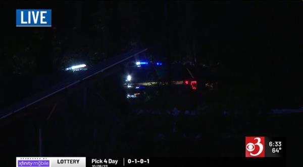 Red and blue police car lights illuminate the darkened path at night