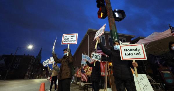 People protest across the street from a proposed migrant tent camp site at 38th Street and California Avenue in Chicago on Nov. 16, 2023. 