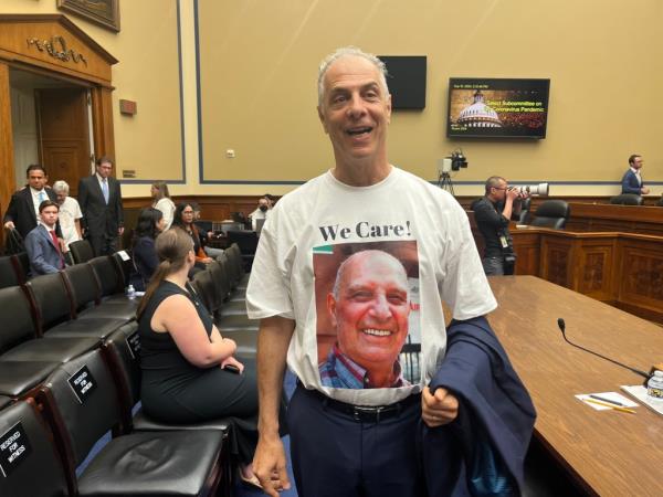 "Who cares?" Daniel Arbeeny's white T-shirt reads on the back side.