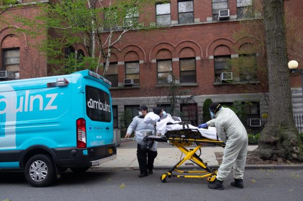 Ambulance workers pickup an elderly man from Cobble Hill Health Center,
