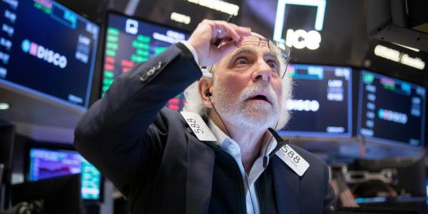 A trader works at the New York Stock Exchange NYSE