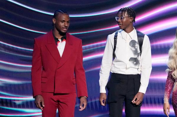Bronny James, left, and Bryce James walk out to present their father, Los Angeles Lakers' LeBron James, with the award for best record-breaking performance at the ESPY awards in 2023.