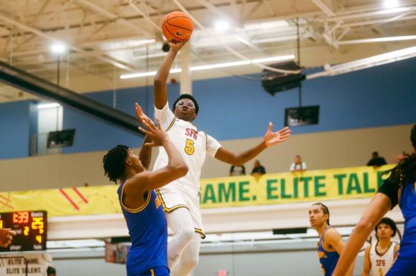 Bryce James (5) looks to float the ball against Team Boo Williams during the Nike Elite Youth Basketball League session one.