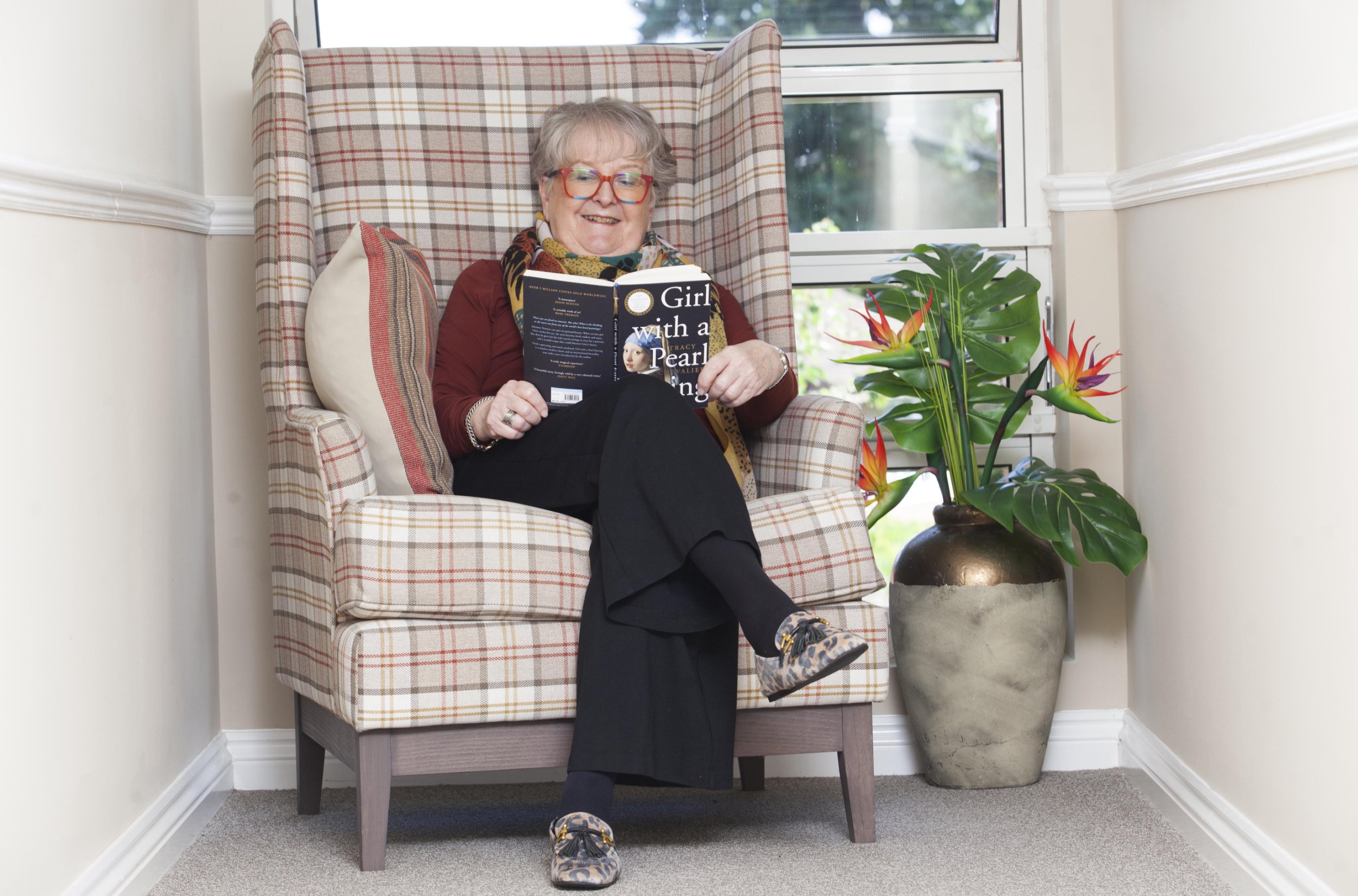 Gill Ross and her apartment in Bagshot, Surrey are the subject of a What I Own feature. This picture shows Gill Ross just outside her apartment in an area she calls her reading nook.