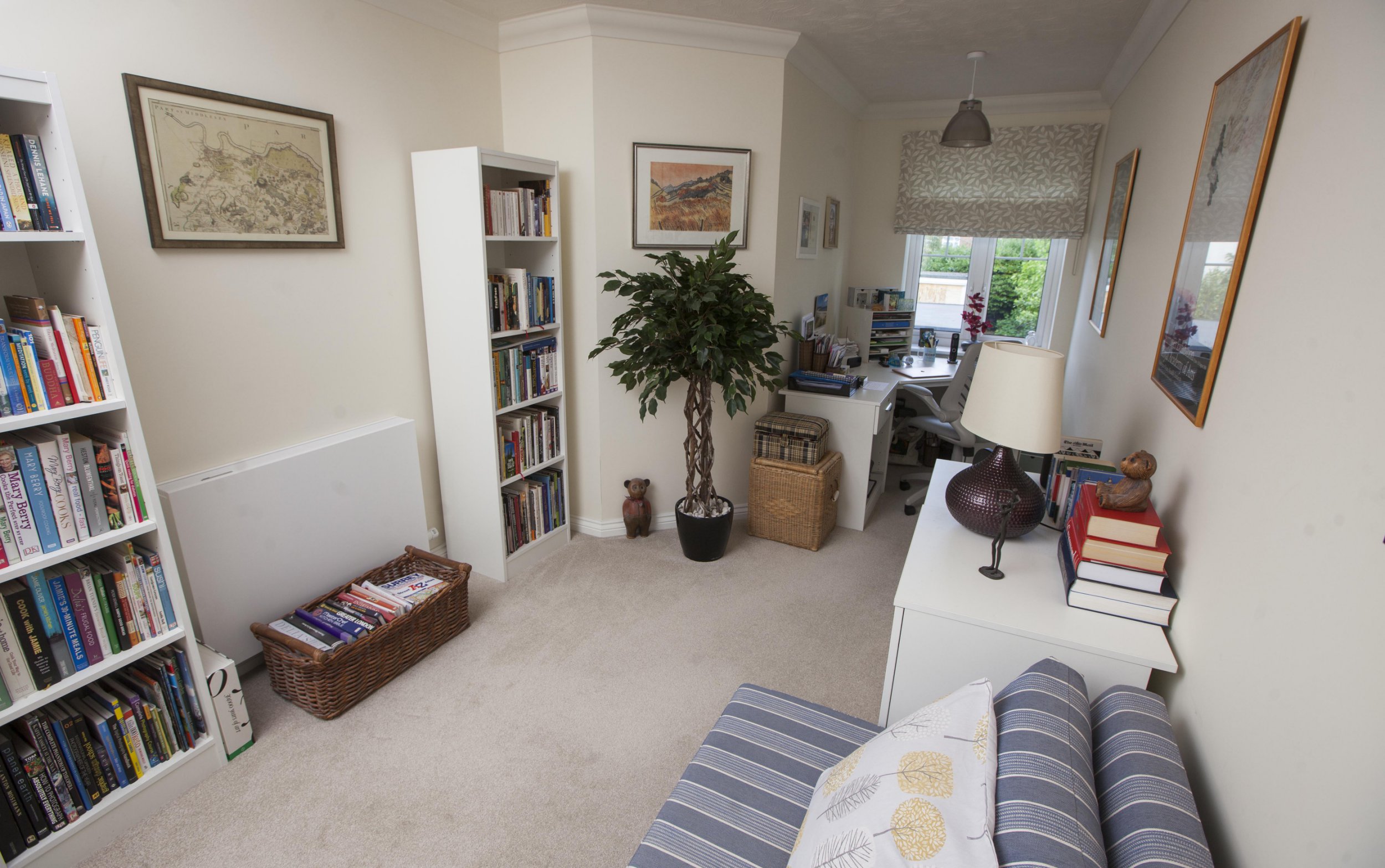 Gill Ross and her apartment in Bagshot, Surrey are the subject of a What I Own feature. This picture shows the second bedroom that has become the office/library.