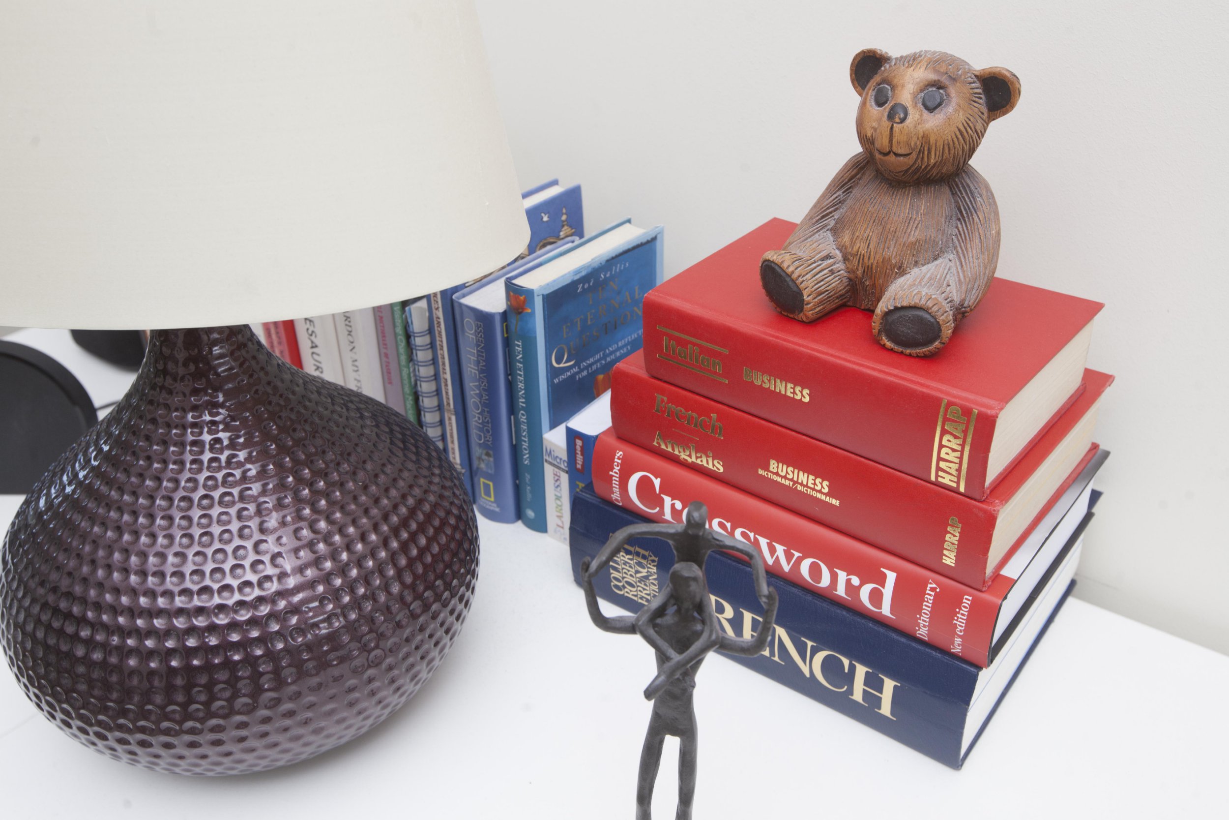 Gill Ross and her apartment in Bagshot, Surrey are the subject of a What I Own feature. This picture shows a bear perched on a stack of books in the office/library.