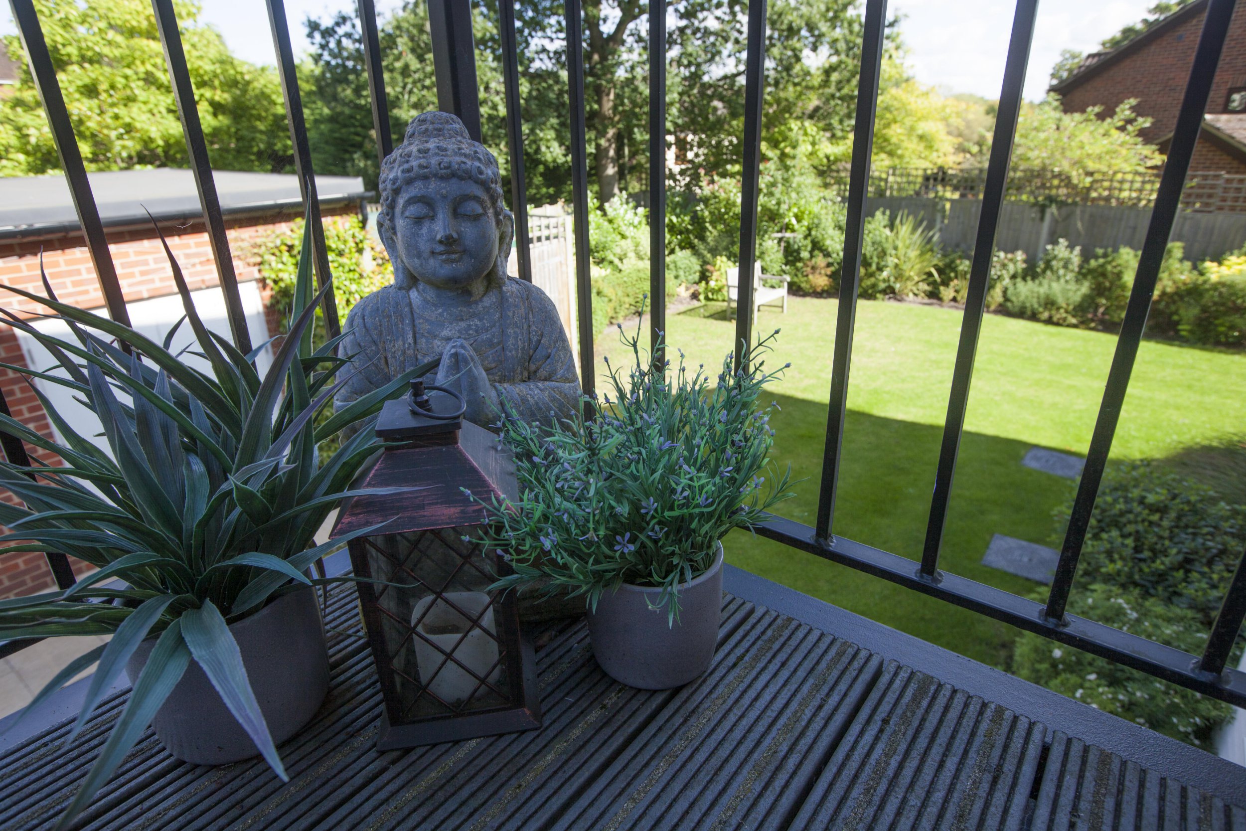 Gill Ross and her apartment in Bagshot, Surrey are the subject of a What I Own feature. This picture shows a concrete statue of Buddah on Gill's balcony.