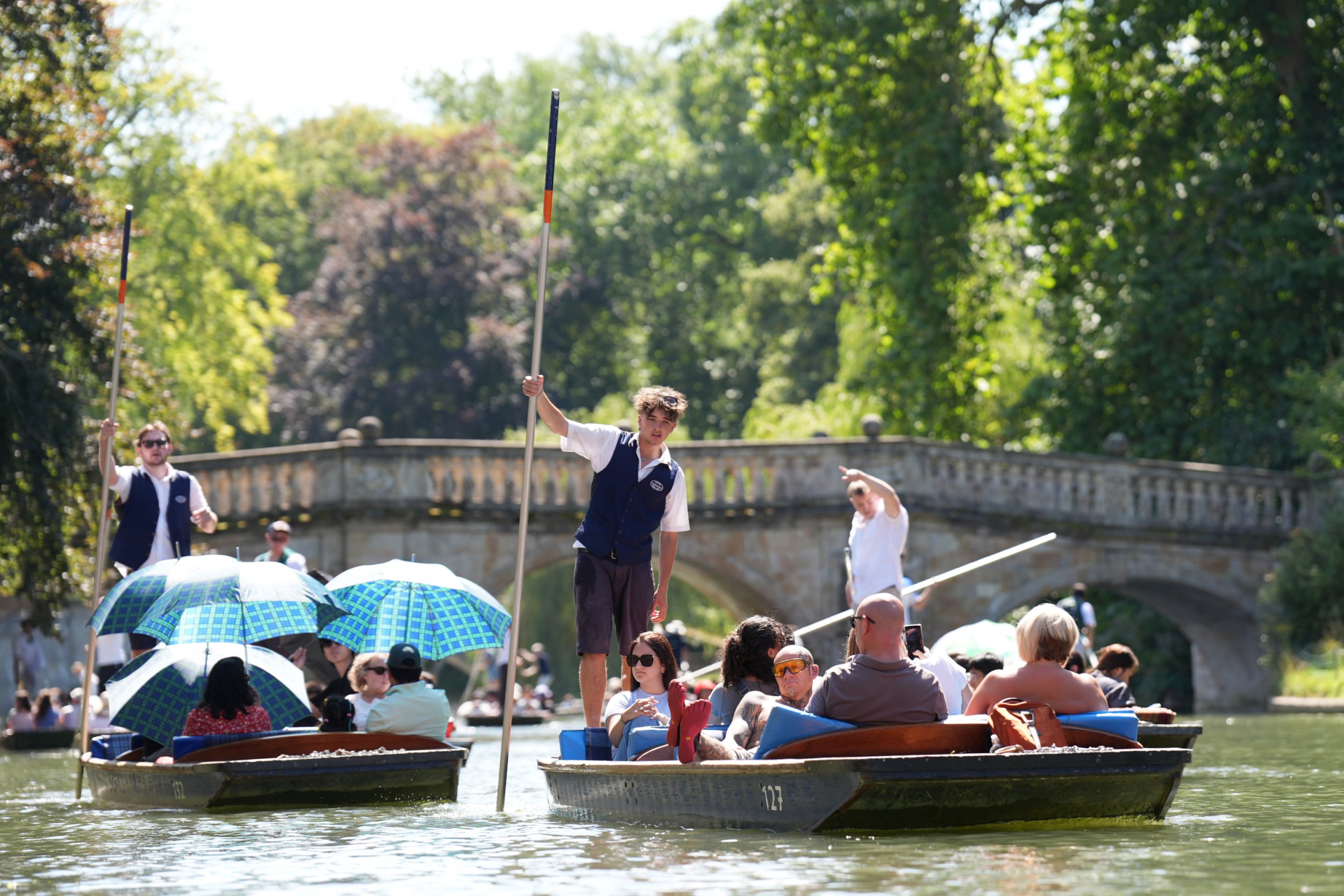 People enjoy punt tours along the River Cam in Cambridge in hot UK weather
