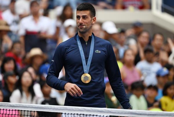 Novak Djokovic wears his Olympic gold medal during Arthur Ashe Kids Day at the U.S. Open on Aug. 24, 2024.