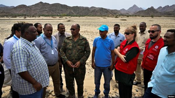 Governor of Sudan's Red Sea State Mustafa Mohammed Nour, center, stands with a group from the United Nations, Sudanese Red Crescent and Sudanese Red Cross in Port Sudan on Aug. 27, 2024. Humanitarian aid access has been restored through the northern Dabbah Road from Port Sudan.