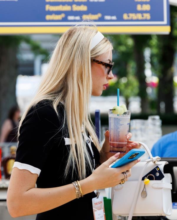 UK influencer Mia Challiner holding a Honey Deuce cocktail at the 2024 US Open Championships in Queens, New York