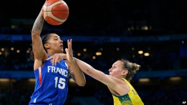 Gabby Williams (15), of France, shoots over Steph Talbot (6), of Australia, in a women's basketball game at the 2024 Summer Olympics, in Villeneuve-d'Ascq, France, Aug. 4, 2024.
