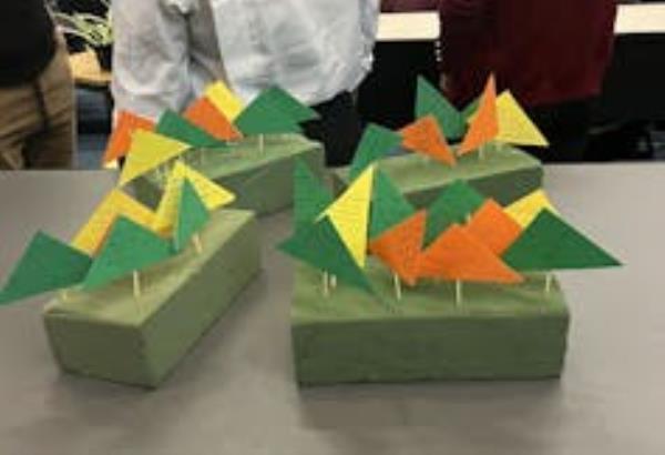 Orange and green pieces of paper stuck into little platforms