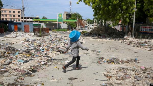 A pedestrian walks along a street in downtown Port-au-Prince, Haiti, on Sept. 23, 2024. Prime Minister Garry Conille said on Sept. 25 that Haiti is far from winning its war against the gangs that control a large part of the capital, Port-au-Prince.