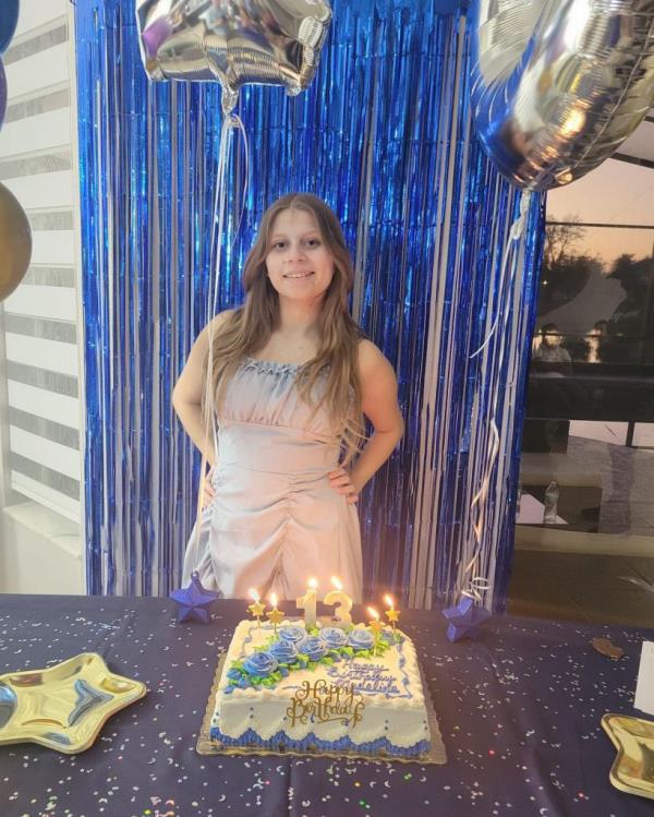 Madeline Soto posing with a birthday cake.