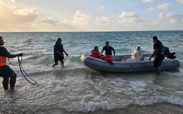 Samoa Fire and Emergency Services Authority staff rescue crew of the HMNZS Manawanui after it ran aground in Samoa.