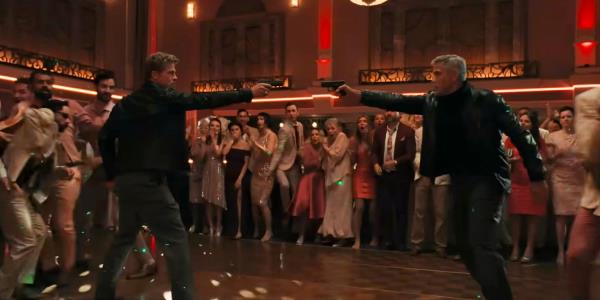 Nick (Brad Pitt) and Jack (George Clooney) pointing a gun at each other during a wedding in WOLFS