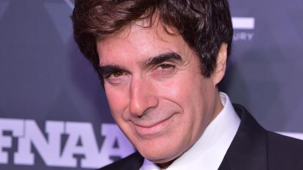 David Copperfield in suit smiling