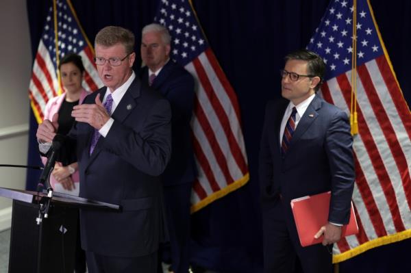 U.S. Representative Mark Amodei speaking at a podium while fellow House Republican leaders Elise Stefanik, Tom Emmer, and Mike Johnson listen intently at the Republican National Committee headquarters