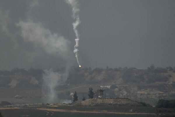 Smoke from a flare is seen during an Israeli bombardment in the Gaza Strip. Picture: AP Photo/Leo Correa Smoke from a flare is seen during an Israeli bombardment in the Gaza Strip. Picture: AP Photo/Leo Correa