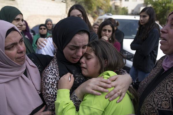 Women cry while they take the last look at the body of Ayham Shafe'e, 14, during his funeral in the West Bank city of Ramallah. Picture: AP Photo/Nasser Nasser Women cry while they take the last look at the body of Ayham Shafe'e, 14, during his funeral in the West Bank city of Ramallah. Picture: AP Photo/Nasser Nasser