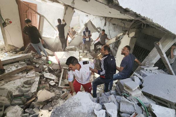 Palestinians look for survivors in the rubble of a destroyed building following an Israeli airstrike in Bureij refugee camp, Gaza Strip, Thursday, Nov. 2, 2023. (AP Photo/Hassan Eslaiah) Palestinians look for survivors in the rubble of a destroyed building following an Israeli airstrike in Bureij refugee camp, Gaza Strip, Thursday, Nov. 2, 2023. (AP Photo/Hassan Eslaiah)