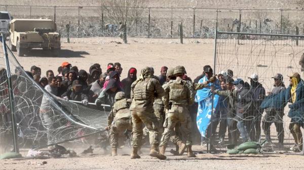Migrants battle Texas National Guard soldiers at the border, El Paso, Thursday, March 21, 2024.