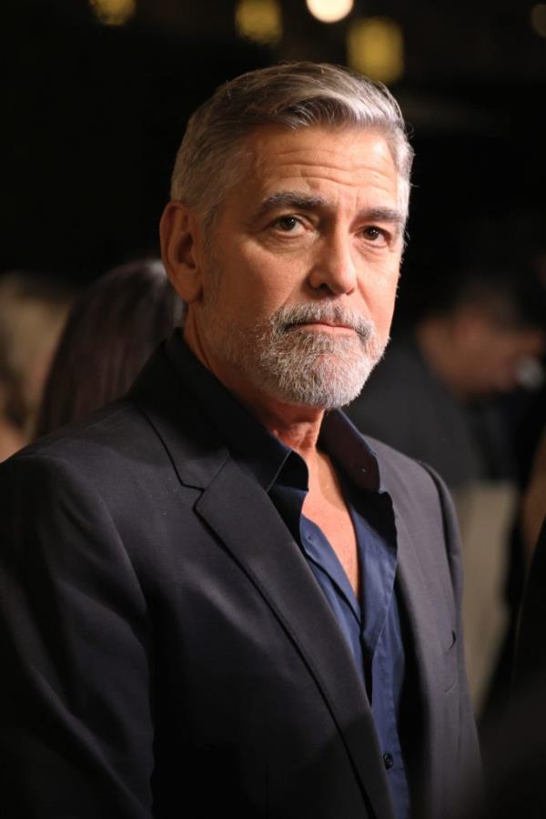 George Clooney, with a beard and mustache, wearing a suit at the Los Angeles premiere of Amazon MGM Studios' "The Boys in the Boat